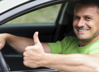 Happy young man with new car