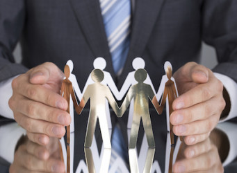 Businessman protecting paper people