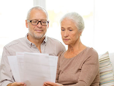 Elderly Couple Looking At Their Insurance Papers